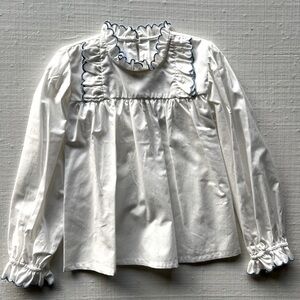 Scalloped litt girl blouse with blue trim. Beautiful for any occasion.